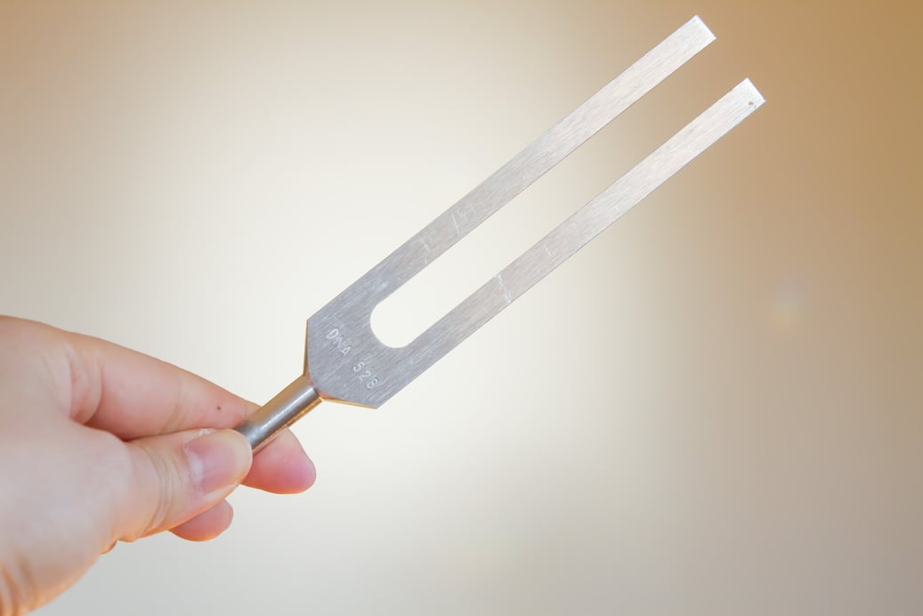 tuning fork and crystal on table .